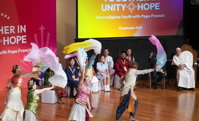 Pope Francis, right, attends an interreligious meeting with young people at the Catholic Junior College in Singapore, Friday, Sept. 13, 2024. Pope Francis is wrapping up his visit to Singapore by praising its tradition of interfaith harmony. (AP Photo/Gregorio Borgia)