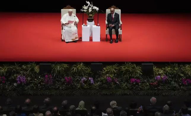 Pope Francis addresses Singapore's President Tharman Shanmugaratnam, right, and the audience during a meeting with the authorities, civil society and the diplomatic corps in the theatre of the Cultural Centre of the National University of Singapore, Thursday, Sept. 12, 2024. Pope Francis flew to Singapore on Wednesday for the final leg of his trip through Asia, arriving in one of the world's richest countries from one of its poorest after a record-setting final Mass in East Timor. (AP Photo/Gregorio Borgia)