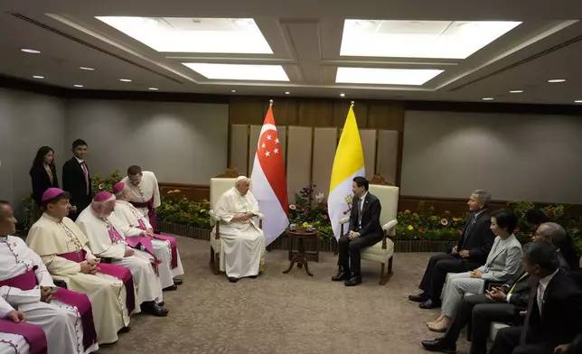 Pope Francis meets with the Prime Minister of Singapore, Lawrence Wong, center right, at the Parliament House in Singapore, Thursday, Sept. 12, 2024. Pope Francis flew to Singapore on Wednesday for the final leg of his trip through Asia, arriving in one of the world's richest countries from one of its poorest after a record-setting final Mass in East Timor. (AP Photo/Gregorio Borgia, pool)