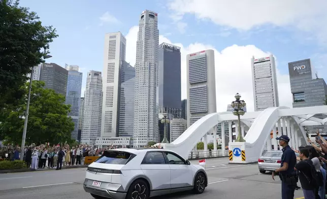 The car carrying Pope Francis leaves from the Parliament House in Singapore, Thursday, Sept. 12, 2024. (AP Photo/Vincent Thian)