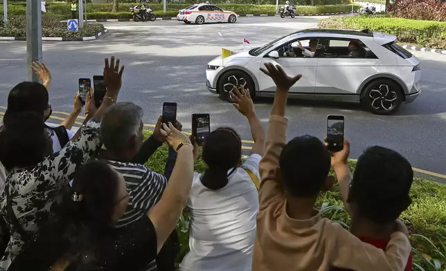 Pope Francis waves as he arrives at the National Stadium to celebrate a mass in Singapore, Thursday, Sept. 12, 2024. (AP Photo/Suhaimi Abdullah)