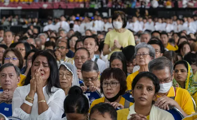 The faithful follow Pope Francis presiding over a mass 'In Memory of the Most Holy Name of Mary' celebrated by the Archbishop of Singapore, Cardinal William Goh Seng Chye at the Singapore SportsHub National Stadium, Thursday, Sept. 12, 2024. Pope Francis has praised Singapore's economic development as a testament to human ingenuity. But he's urging the city-state to look after the weakest too. Francis made the remarks Thursday on the final leg of the longest and farthest tour of his papacy. (AP Photo/Gregorio Borgia)