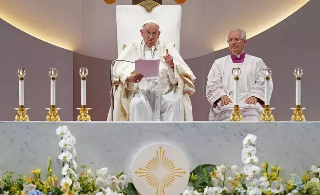 Pope Francis, left, presiders over a holy mass at the SportsHub National Stadium in Singapore, Thursday, Sept. 12, 2024. (AP Photo/Vincent Thian)