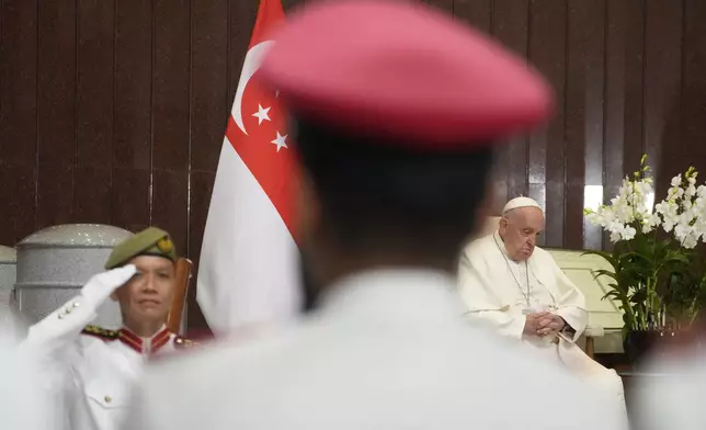 Pope Francis attends a welcome ceremony at the Parliament House in Singapore, Thursday, Sept. 12, 2024. Pope Francis flew to Singapore on Wednesday for the final leg of his trip through Asia, arriving in one of the world's richest countries from one of its poorest after a record-setting final Mass in East Timor. (AP Photo/Gregorio Borgia)