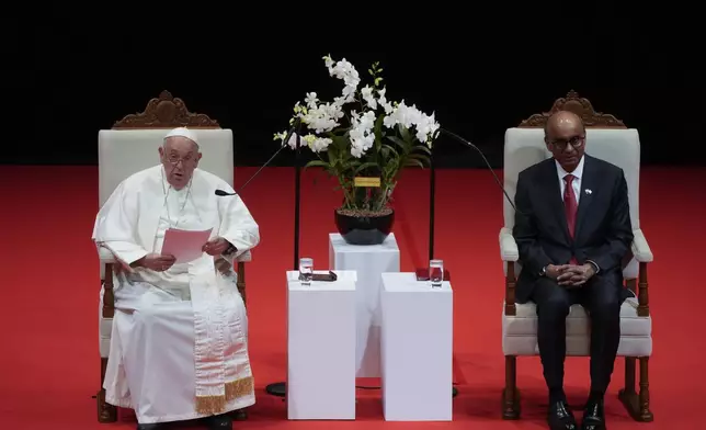 Pope Francis addresses Singapore's President Tharman Shanmugaratnam, right, and the audience during a meeting with the authorities, civil society and the diplomatic corps in the theatre of the Cultural Centre of the National University of Singapore, Thursday, Sept. 12, 2024. Pope Francis flew to Singapore on Wednesday for the final leg of his trip through Asia, arriving in one of the world's richest countries from one of its poorest after a record-setting final Mass in East Timor. (AP Photo/Gregorio Borgia)