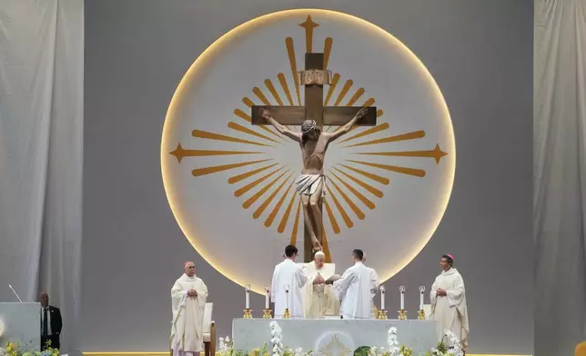 Pope Francis presides over a mass 'In Memory of the Most Holy Name of Mary' celebrated by the Archbishop of Singapore, Cardinal William Goh Seng Chye at the Singapore SportsHub National Stadium, Thursday, Sept. 12, 2024. Pope Francis has praised Singapore's economic development as a testament to human ingenuity. But he's urging the city-state to look after the weakest too. Francis made the remarks Thursday on the final leg of the longest and farthest tour of his papacy. (AP Photo/Gregorio Borgia)