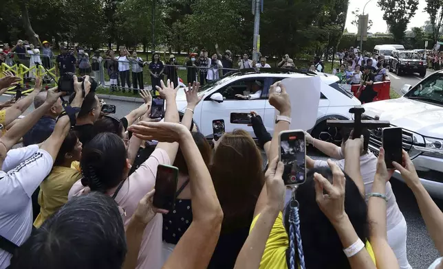 People react as Pope Francis arrives at St Theresa's Home in Singapore, Friday, Sept. 13, 2024. (AP Photo/Suhaimi Abdullah)