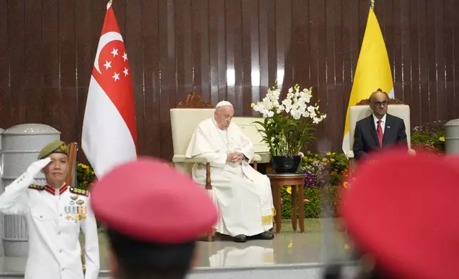 Pope Francis attends a welcome ceremony with the President of the Singapore Republic Tharman Shanmugaratnam, right, at the Parliament House in Singapore, Thursday, Sept. 12, 2024. Pope Francis flew to Singapore on Wednesday for the final leg of his trip through Asia, arriving in one of the world's richest countries from one of its poorest after a record-setting final Mass in East Timor. (AP Photo/Gregorio Borgia)