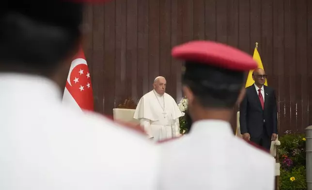 Pope Francis attends a welcome ceremony with the President of the Singapore Republic Tharman Shanmugaratnam, right, at the Parliament House in Singapore, Thursday, Sept. 12, 2024. Pope Francis flew to Singapore on Wednesday for the final leg of his trip through Asia, arriving in one of the world's richest countries from one of its poorest after a record-setting final Mass in East Timor. (AP Photo/Gregorio Borgia)