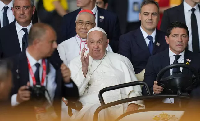 Pope Francis waves as he arrives to lead a holy mass at the SportsHub National Stadium in Singapore, Thursday, Sept. 12, 2024. (AP Photo/Vincent Thian)