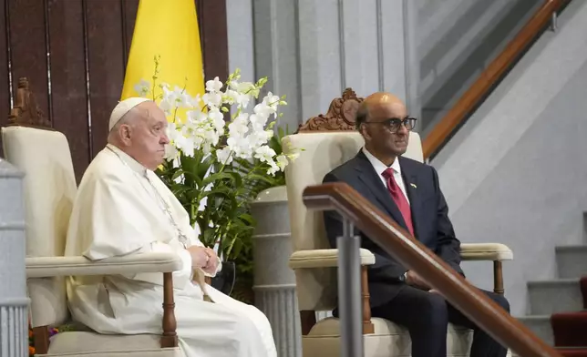 Pope Francis attends a welcome ceremony with the President of the Singapore Republic Tharman Shanmugaratnam, right, at the Parliament House in Singapore, Thursday, Sept. 12, 2024. Pope Francis flew to Singapore on Wednesday for the final leg of his trip through Asia, arriving in one of the world's richest countries from one of its poorest after a record-setting final Mass in East Timor. (AP Photo/Gregorio Borgia)