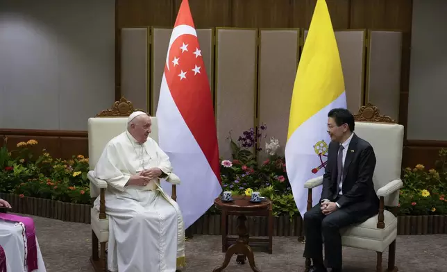 Pope Francis meets with the Prime Minister of Singapore, Lawrence Wong, right, at the Parliament House in Singapore, Thursday, Sept. 12, 2024. Pope Francis flew to Singapore on Wednesday for the final leg of his trip through Asia, arriving in one of the world's richest countries from one of its poorest after a record-setting final Mass in East Timor. (AP Photo/Gregorio Borgia, pool)