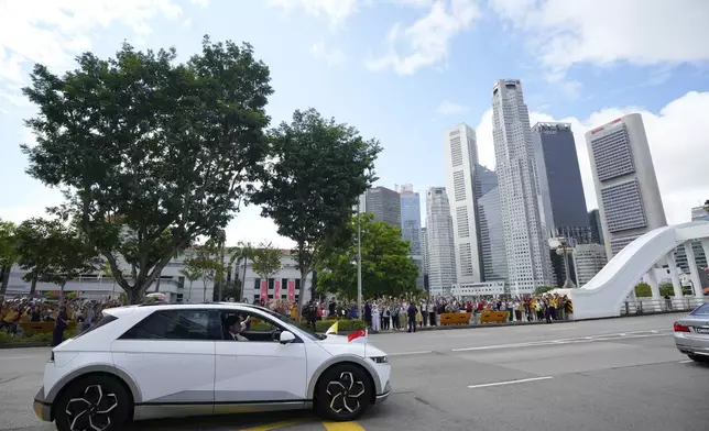 The car carrying Pope Francis leaves from the Parliament House in Singapore, Thursday, Sept. 12, 2024. (AP Photo/Vincent Thian)