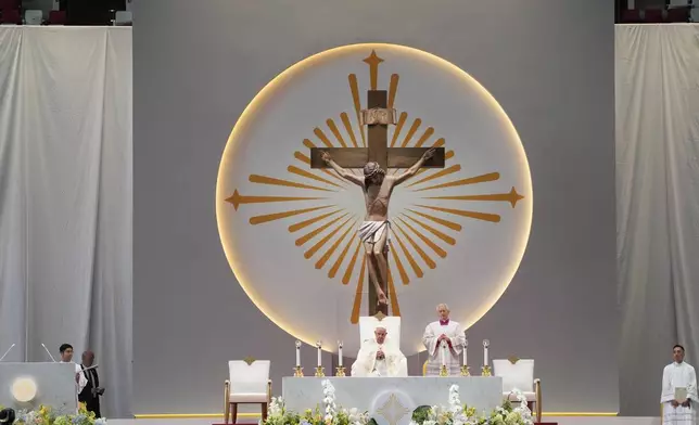 Pope Francis presides over a mass 'In Memory of the Most Holy Name of Mary' celebrated by the Archbishop of Singapore, Cardinal William Goh Seng Chye at the Singapore SportsHub National Stadium, Thursday, Sept. 12, 2024. Pope Francis has praised Singapore's economic development as a testament to human ingenuity. But he's urging the city-state to look after the weakest too. Francis made the remarks Thursday on the final leg of the longest and farthest tour of his papacy. (AP Photo/Gregorio Borgia)