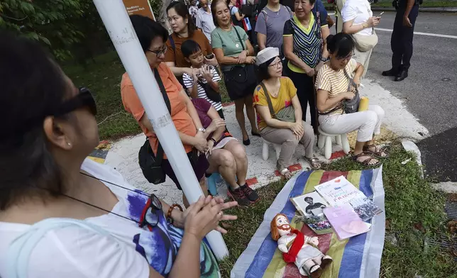 People wait for Pope Francis to arrive outside St Theresa's Home in Singapore, Friday, Sept. 13, 2024.(AP Photo/Suhaimi Abdullah)