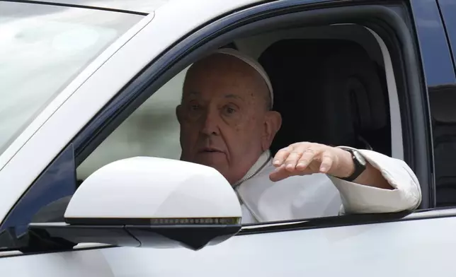 Pope Francis waves from the car, as he leaves from the Parliament House in Singapore, Thursday, Sept. 12, 2024. (AP Photo/Vincent Thian)