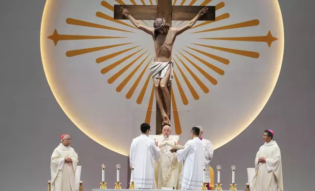 Pope Francis leads a holy mass at the SportsHub National Stadium in Singapore, Thursday, Sept. 12, 2024. (AP Photo/Vincent Thian)