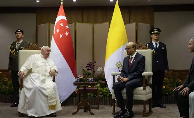 Pope Francis meets with the President of the Singapore Republic Tharman Shanmugaratnam, right, at the Parliament House in Singapore, Thursday, Sept. 12, 2024. Pope Francis flew to Singapore on Wednesday for the final leg of his trip through Asia, arriving in one of the world's richest countries from one of its poorest after a record-setting final Mass in East Timor. (AP Photo/Gregorio Borgia, pool)