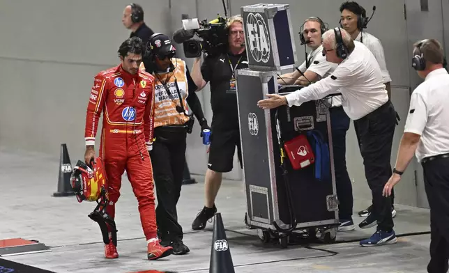 Ferrari driver Carlos Sainz of Spain leaves after he crashed into the track wall during the qualifying session of the Singapore Formula One Grand Prix at the Marina Bay Street Circuit, in Singapore, Saturday, Sept. 21, 2024. (Mohd Rasfan/Pool Photo via AP)