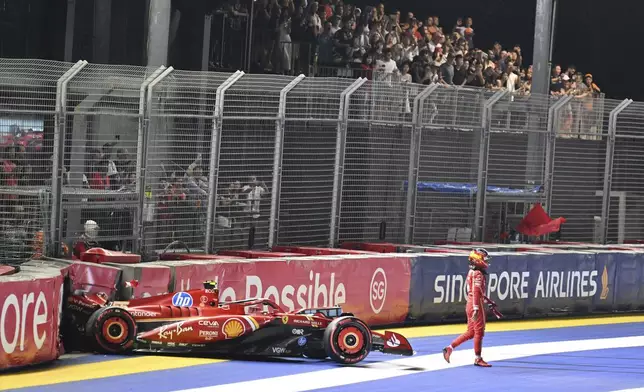 Ferrari driver Carlos Sainz of Spain leaves after he crashed into the track wall during the qualifying session of the Singapore Formula One Grand Prix at the Marina Bay Street Circuit, in Singapore, Saturday, Sept. 21, 2024. (Mohd Rasfan/Pool Photo via AP)