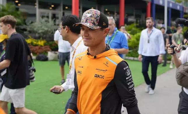 McLaren driver Lando Norris of Britain arrives during the first practice session of the Singapore Formula One Grand Prix at the Marina Bay Street Circuit, in Singapore, Friday, Sept. 20, 2024. (AP Photo/Vincent Thian)