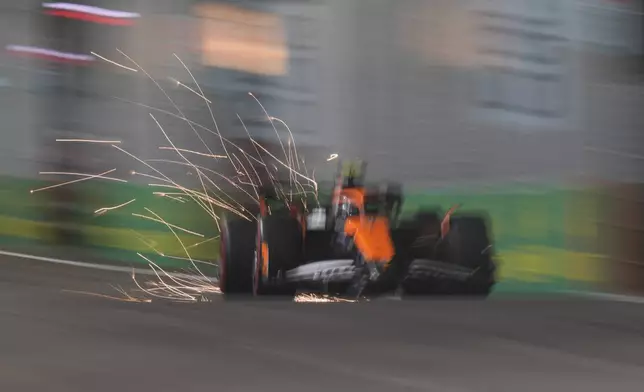 McLaren driver Lando Norris of Britain steers his car during the qualifying session of the Singapore Formula One Grand Prix at the Marina Bay Street Circuit, in Singapore, Saturday, Sept. 21, 2024. (AP Photo/Vincent Thian)