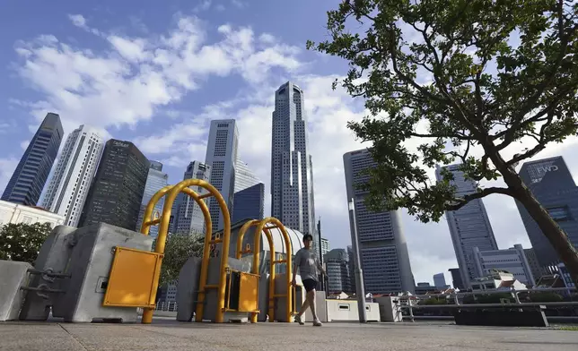 A pedestrian walks along the pavement outside Parliament House, where Pope Francis is scheduled to meet Singapore Prime Minister Lawrence Wong and President Tharman Shanmugaratnam, in Singapore, Saturday, Sept. 7, 2024. (AP Photo/Suhaimi Abdullah)