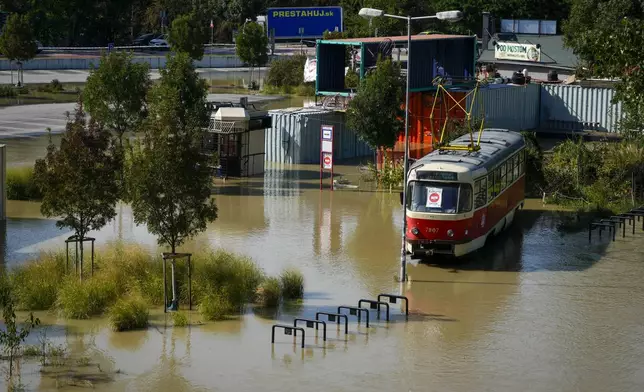 An old tram car is parked in flooded area near the Danube river in Bratislava, Slovakia, Wednesday, Sept. 18, 2024. (AP Photo/Darko Bandic)