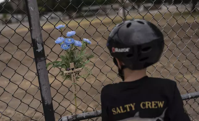 Jax Brown, half-brother of Elijah Ott, who died of a fentanyl overdose at 15, looks at a memorial for Elijah at a skateboard park in Paso Robles, Calif., Friday, Aug. 2, 2024. (AP Photo/Jae C. Hong)