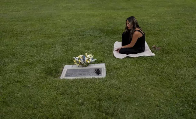 Mikayla Brown visits the grave of her son, Elijah, who died of a fentanyl overdose at 15, in Paso Robles, Calif., Friday, Aug. 2, 2024. (AP Photo/Jae C. Hong)