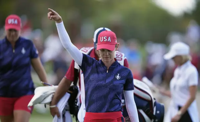 United States' Sarah Schmelzel reacts after putting in on the 14th hole during a Solheim Cup golf tournament fourball match at Robert Trent Jones Golf Club, Friday, Sept. 13, 2024, in Gainesville, Va. (AP Photo/Chris Szagola)