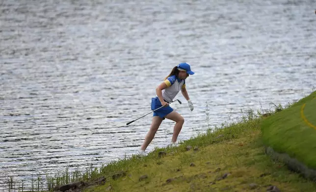 Europe's Leona Maguire climbs up after chipping onto the 11th green during a Solheim Cup golf tournament fourball match at Robert Trent Jones Golf Club, Friday, Sept. 13, 2024, in Gainesville, Va. (AP Photo/Matt York)