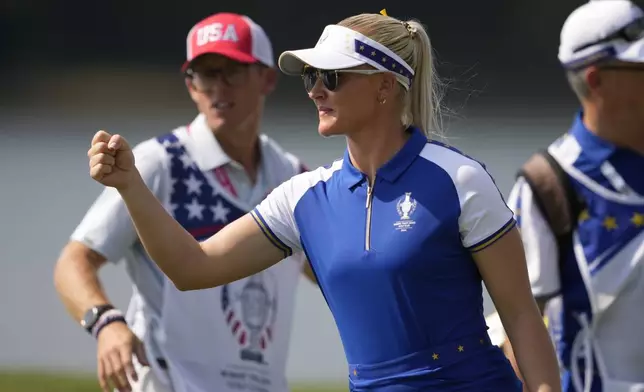 Europe's Charley Hull celebrates after winning a foursome match during a Solheim Cup golf tournament at Robert Trent Jones Golf Club, Saturday, Sept. 14, 2024, in Gainesville, Va. (AP Photo/Matt York)