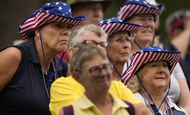 Fans watch from the 11th fairway during a Solheim Cup golf tournament foursomes match at Robert Trent Jones Golf Club, Friday, Sept. 13, 2024, in Gainesville, VA. (AP Photo/Matt York)