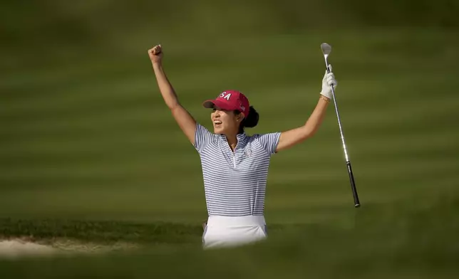 United States' Rose Zhang celebrates after hitting out of a bunker and into the cup on the 13th hole during a Solheim Cup golf tournament fourball match at Robert Trent Jones Golf Club, Saturday, Sept. 14, 2024, in Gainesville, Va. (AP Photo/Matt York)