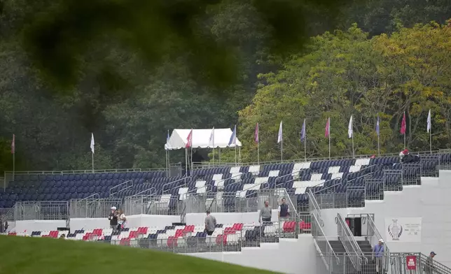 Empty seats on a grandstand are seen on the first hole during a Solheim Cup golf tournament foursomes match at Robert Trent Jones Golf Club, Friday, Sept. 13, 2024, in Gainesville, VA. (AP Photo/Matt York)