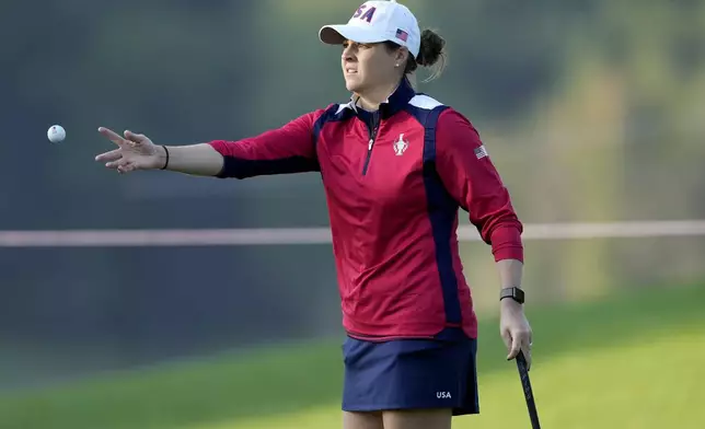 United States' Ally Ewing tosses her ball to her caddie on the first green during a practice round prior to the Solheim Cup golf tournament at the Robert Trent Jones Golf Club, Wednesday, Sept. 11, 2024, in Gainesville, VA. (AP Photo/Matt York)