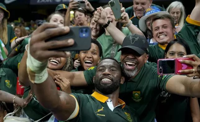 South Africa's captain Siya Kolisi takes pictures with fans as he celebrate his team defeated Argentina winning the rugby championship at Mbombela stadium in Nelspruit, South Africa, Saturday, Sept. 28, 2024. (AP Photo/Themba Hadebe)