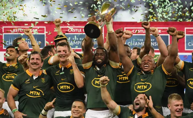 South Africa players celebrate with the trophy after defeating Argentina and winning the rugby championship at Mbombela stadium in Nelspruit, South Africa, Saturday, Sept. 28, 2024. (AP Photo/Themba Hadebe)