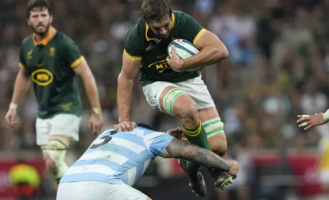 South Africa's Eben Etzebeth, right, is tackled by Argentina's Joel Sclavi during a rugby championship test match at Mbombela stadium in Nelspruit, South Africa, Saturday, Sept. 28, 2024. (AP Photo/Themba Hadebe)