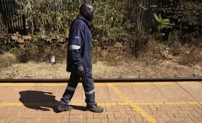 A patient walks around as he tests eye glasses outside the Phelophepa eye clinic carriage, in Tembisa, east of Johannesburg, South Africa, Thursday, Aug. 22, 2024. (AP Photo/Themba Hadebe)