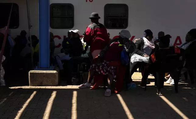 Patients queue for an eyes test, outside the Phelophepa eye clinic carriage, in Tembisa, east of Johannesburg, South Africa, Thursday, Aug. 22, 2024. (AP Photo/Themba Hadebe)