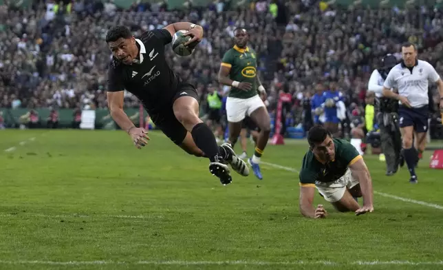 New Zealand's Caleb Clarke runs to score a try during a rugby championship test match between South Africa and New Zealand at Ellis Park stadium in Johannesburg, South Africa, Saturday, Aug. 31, 2024. (AP Photo/Themba Hadebe)