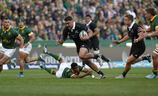 New Zealand's Codie Taylor, makes off with the ball during a rugby championship test match between South Africa and New Zealand at Cape Town Stadium South Africa, Saturday, Sept. 7, 2024. (AP Photo/Nardus Engelbrecht)