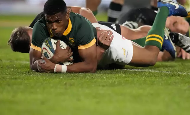 South Africa's Grant Williams scores a try during a rugby championship test match between South Africa and New Zealand at Ellis Park stadium in Johannesburg, South Africa, Saturday, Aug. 31, 2024. (AP Photo/Themba Hadebe)