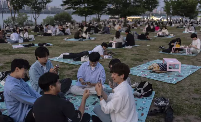 People spend time in Yeouido Hangang Park, a popular destination for both residents and tourists, in Seoul, Wednesday, May 22, 2024. (AP Photo/Jae C. Hong)