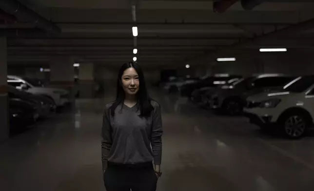 Shin Nari, a 34-year-old graduate student who says she is worried about nuclear war, stands for a portrait in an underground parking lot that also serves as a bomb shelter in Seoul, Tuesday, May 28, 2024. (AP Photo/Jae C. Hong)