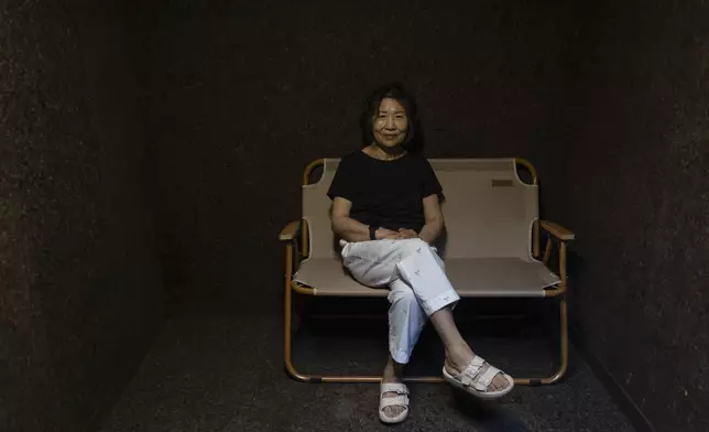 Jung Myungja, 73, sits for a portrait in a small bunker dug into the yard of her home in Seoul, Tuesday, May 28, 2024. (AP Photo/Jae C. Hong)