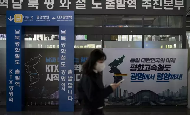 A commuter walks past a banner that reads, "The Future of a Unified Korea, Peace High-Speed Railway, from Gwangmyeong to Pyongyang," at Gwangmyeong station in Gwangmyeong, South Korea, Thursday, May 16, 2024. (AP Photo/Jae C. Hong)