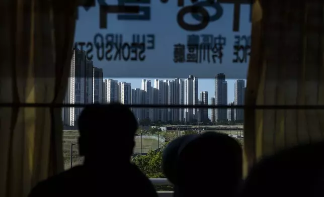 A tourist views high-rise apartment buildings from a bus in Incheon, South Korea, Thursday, May 16, 2024. (AP Photo/Jae C. Hong)